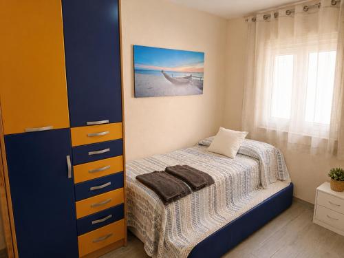a small bedroom with a bed and a cabinet at GR - Polvorín Oasis in Valladolid