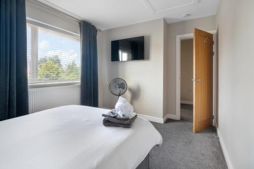 a bedroom with a bed with a mirror and a window at Perfect Getaway 1 in Middlesbrough