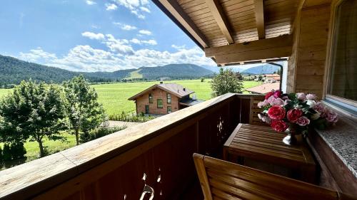 a vase of flowers on a balcony with a view at Jagd Chalet in Leutasch