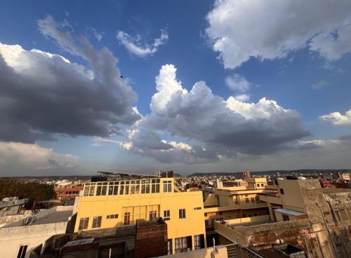 a view of a city with clouds in the sky at The Pink Nest - Backpackers Abode in Jaipur