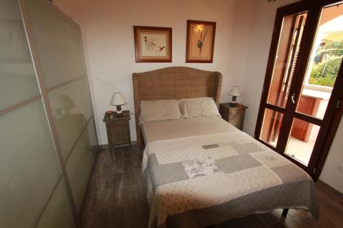a small bedroom with a bed and a window at Villarios Castello in Villarios
