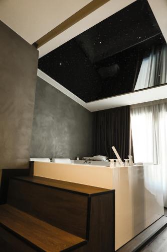 a room with a desk with a star ceiling at Xhasen Hotel & Café in Tirana