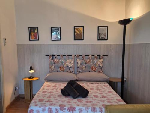 a bedroom with a bed with a blanket and a lamp at Appartamento Aurora Pro in Altamura