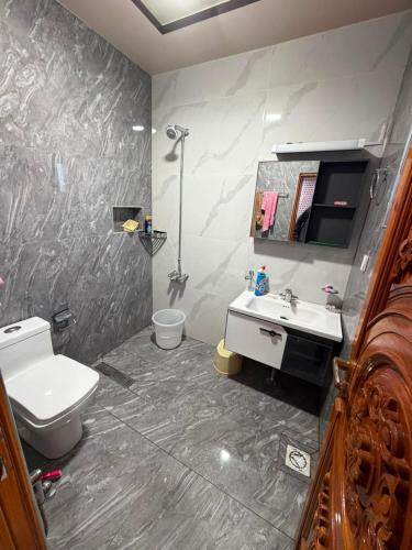a bathroom with a toilet and a sink at Galiyat Peak in Abbottabad