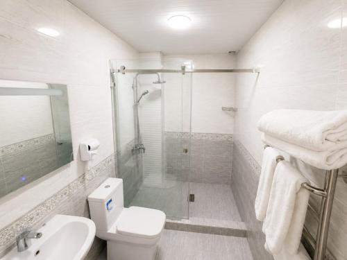 a bathroom with a shower and a toilet and a sink at HUMO PLAZA in Fergana