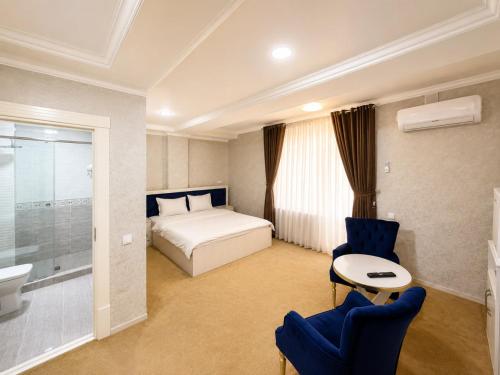 a hotel room with a bed and a bathroom at HUMO PLAZA in Fergana