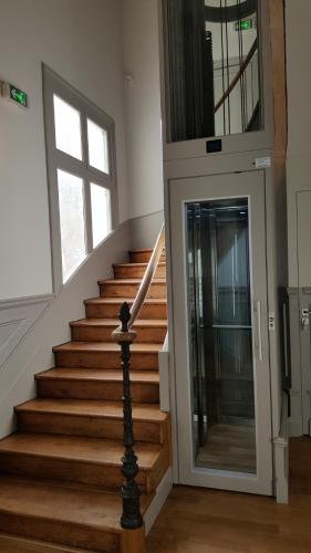 a staircase in a house with a glass door at Résidence de Tourisme Central Parc Tours in Tours