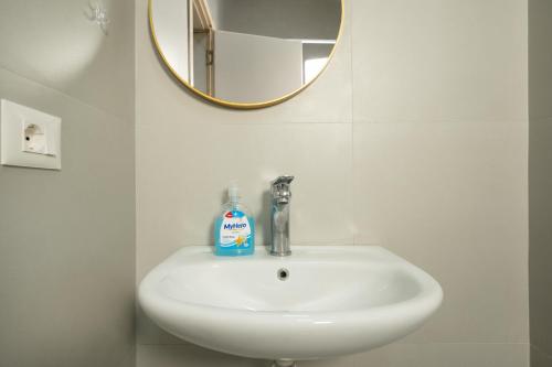 a white sink in a bathroom with a mirror at MaisonNova Deluxe 2 in Tirana