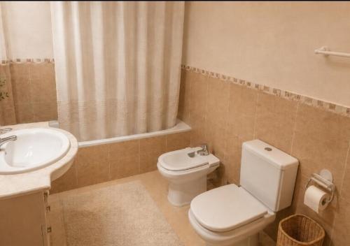 a bathroom with a toilet and a sink at Casa Roda de Bará & Spa in Roda de Bará