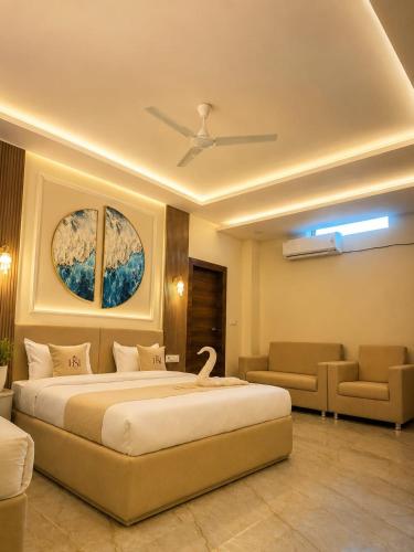 a bedroom with a large bed with a swan on it at Hotel Shanvi Inn in Jabalpur