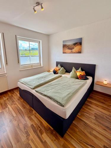 a bedroom with a large bed in a room at Schnütgenhof Appartements in Attendorn