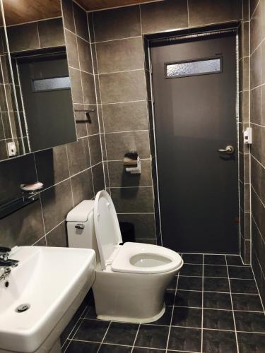 a bathroom with a toilet and a sink at Us on Earth Guesthouse in Danyang