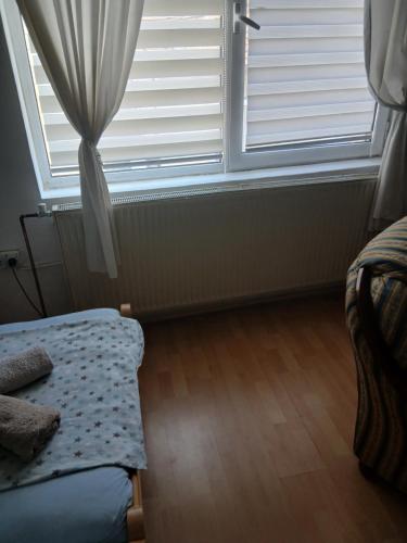 a bedroom with a bed and a window at Aleksinac Centar Two-Bedroom Apartment in Aleksinac