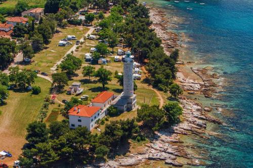 an aerial view of a lighthouse next to the water at Villas Faro in Bašanija