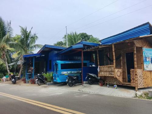 a blue truck parked in front of a building at Lhady Roxy in Siquijor
