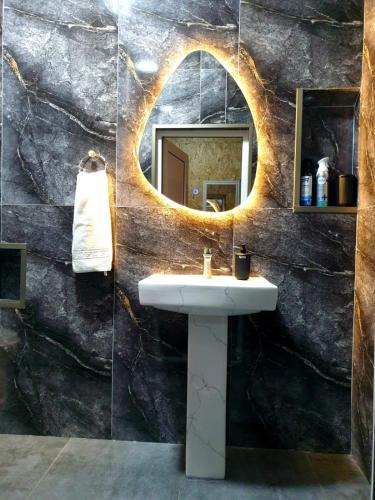a bathroom with a sink and a mirror at George - Guest House Shekvetili in K'vemo Natanebi