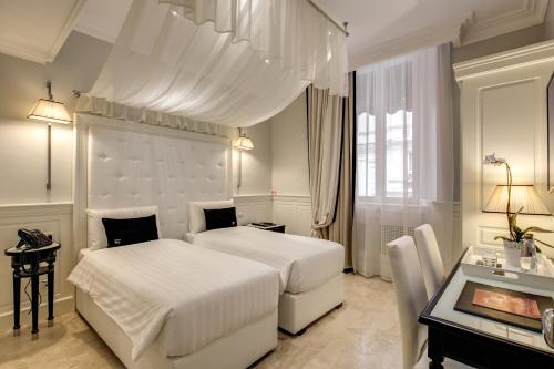 Postel nebo postele na pokoji v ubytování Hotel Tito