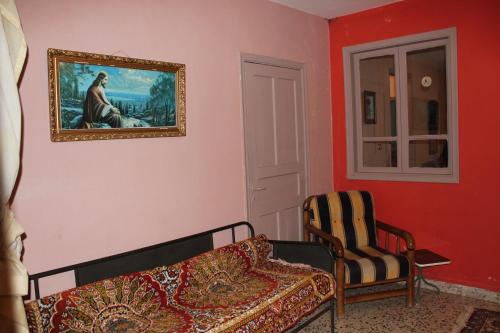 a living room with a couch and a painting on the wall at Bauhaus Motel in Bcharré