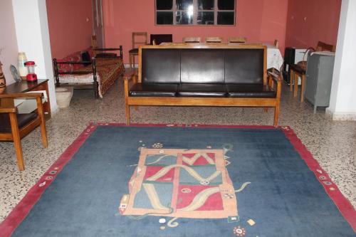 a living room with a couch and a rug at Bauhaus Motel in Bcharré