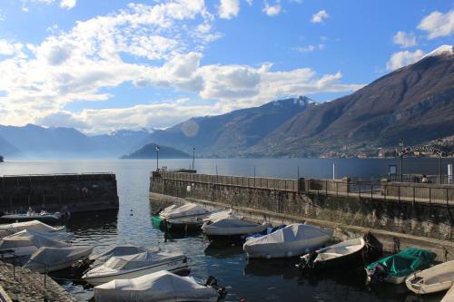 a group of boats docked at a dock on a lake at Casa Mia Apartment in Bellagio
