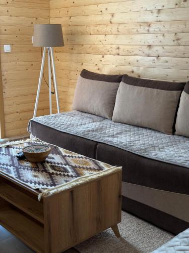 a bedroom with a bed and a coffee table at Apartman Bakic in Kolašin
