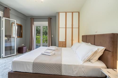 a bedroom with a large bed with towels on it at Popi's apartment in Argostoli