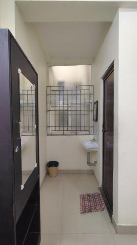 a bathroom with a sink and a mirror at Radhe Krishna Guest House in Srīrangam