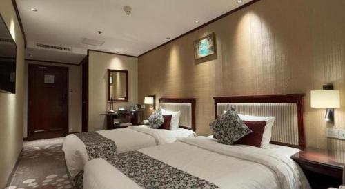 a hotel room with two beds in a room at Macau Masters Hotel in Macau