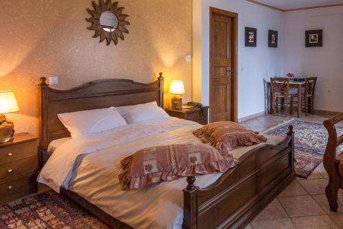 a bedroom with a large bed and a mirror at Studio Merses in Mikrón Khoríon