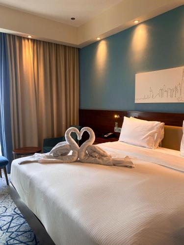 a hotel room with a bed with two swans carved into it at Ayushmaan Hotel - near Jabalpur Railway Station in Jabalpur