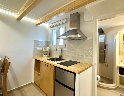 a kitchen with a sink and a stove at Sul Mare Suite in Agia Kiriaki Beach