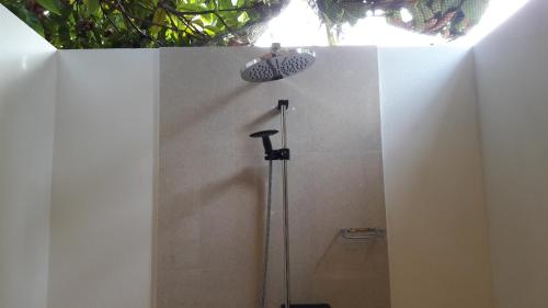 a shower stall in a bathroom with a light at Holiday Garden Rasdhoo in Rasdu