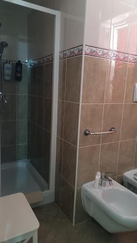 a bathroom with a shower and a sink and a tub at Villa Stella in Praia a Mare