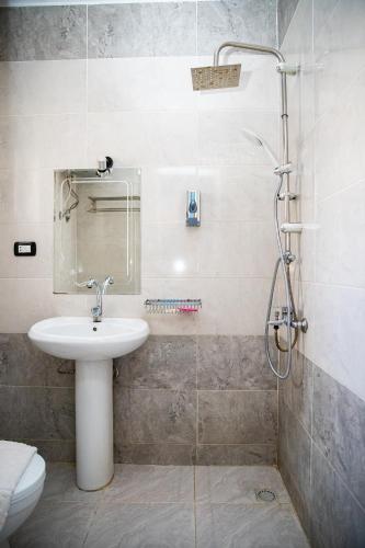 a bathroom with a sink and a shower at Golden Sun Hotel - Hurghada in Hurghada