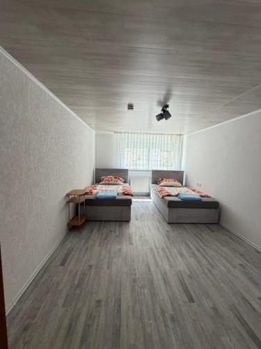 a room with two beds and a window at Müllers Bergnest in Deggingen