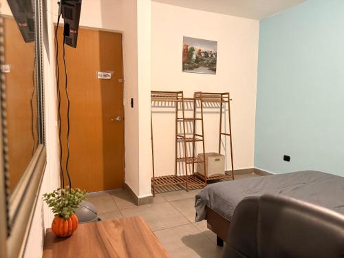 a room with a room with a bed and a table at Casa súper Equipada Cumbres Dominio in Monterrey