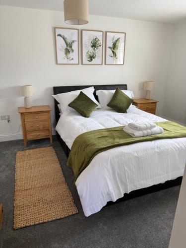 a bedroom with a large bed and two night stands at 25 Birch House in Oswestry