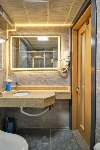a bathroom with a sink and a mirror at Sirkeci Ersu Hotel & SPA in Istanbul