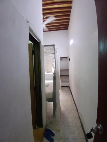 a hallway of a room with a sink and a bathroom at Lamu Sunsail Hotel in Lamu