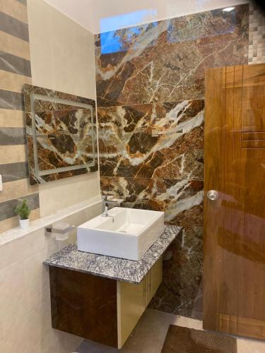 a bathroom with a sink and a mirror at Harbour Front Villa in Trincomalee