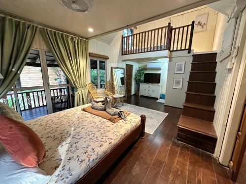 a bedroom with a bed and a staircase in a room at Rumah D'Rhu, Zaki's Residence in Marang