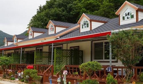 a large house with a gambrel roof at Buan Mul Love Pension in Buan