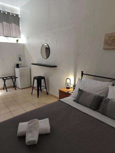 a bedroom with a large bed and a bathroom at Afrodite's Room 1 in Kámbos