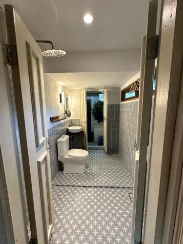 a bathroom with a toilet and a sink at Rumah D'Rhu, Zaki's Residence in Marang