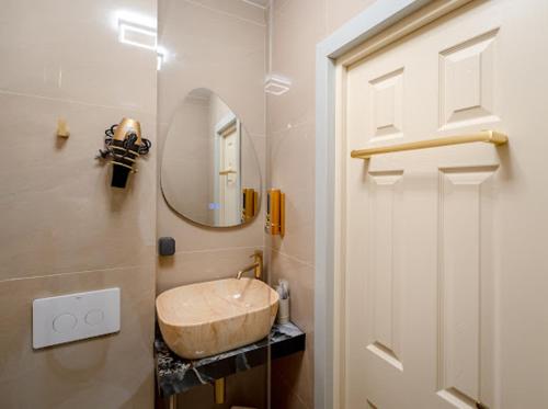a bathroom with a sink and a mirror at Luna Boutique in Bucharest