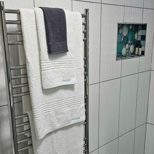 a towel rack in a bathroom with three towels at Aandster in Paternoster