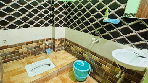 a bathroom with a sink and a toilet at New royal dormitory in Raipur