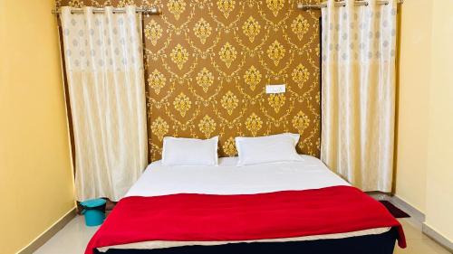 a bedroom with a large bed with a red blanket at New royal dormitory in Raipur
