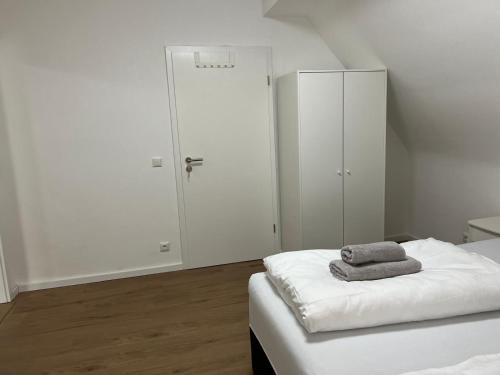 a white room with a bed and a closet at Premium Apart Villa Hamburg in Hamburg