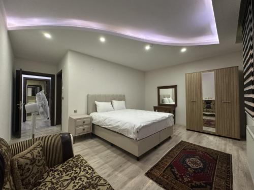 a bedroom with a bed and a living room at Göreme Apartment in Göreme